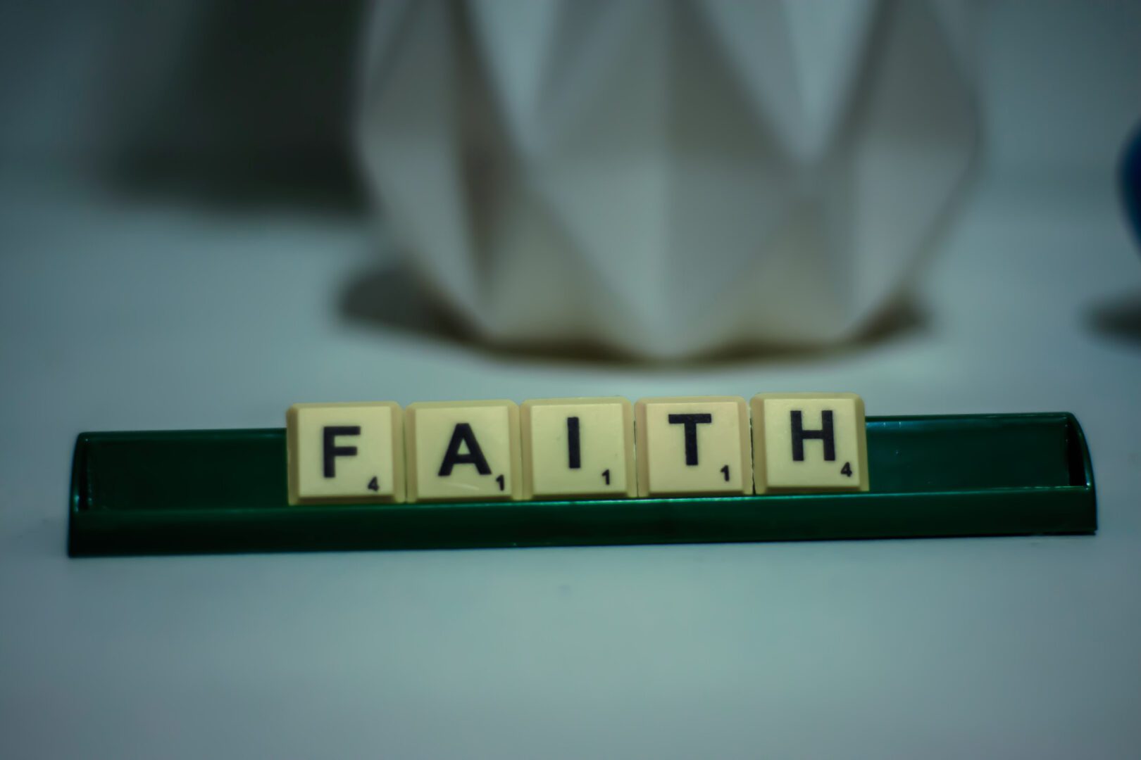 A close up of the word faith spelled out in scrabble tiles