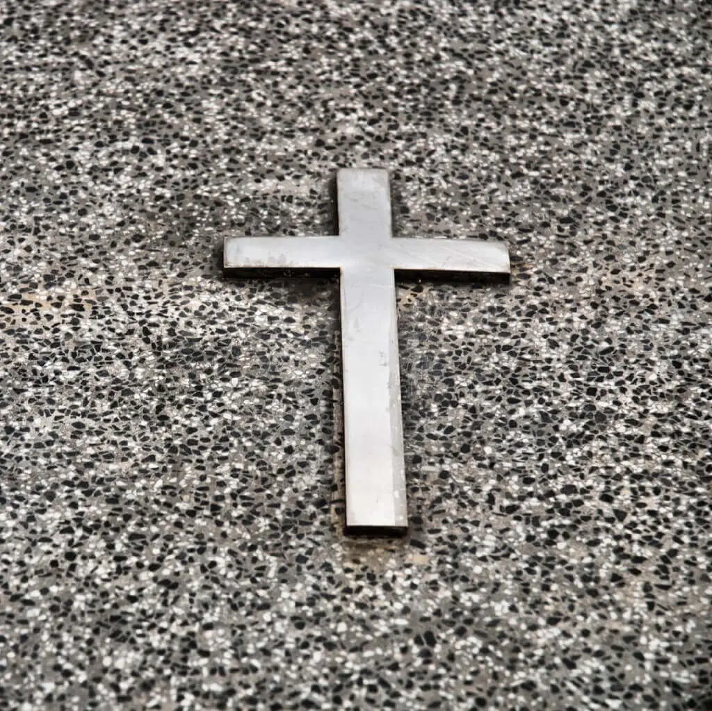 A cross is shown on the ground.